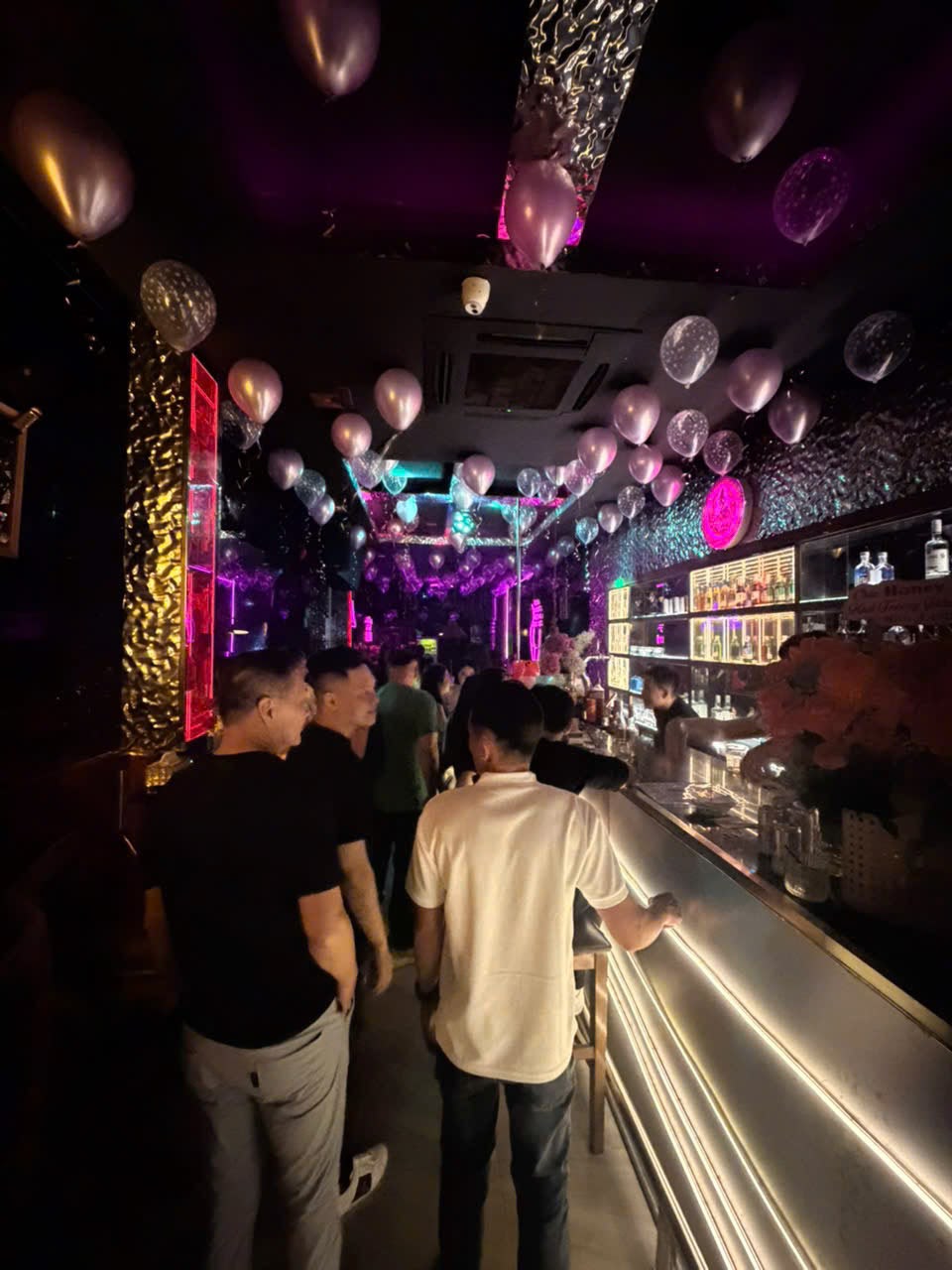 Guests at the bar at Honey Bar Saigon