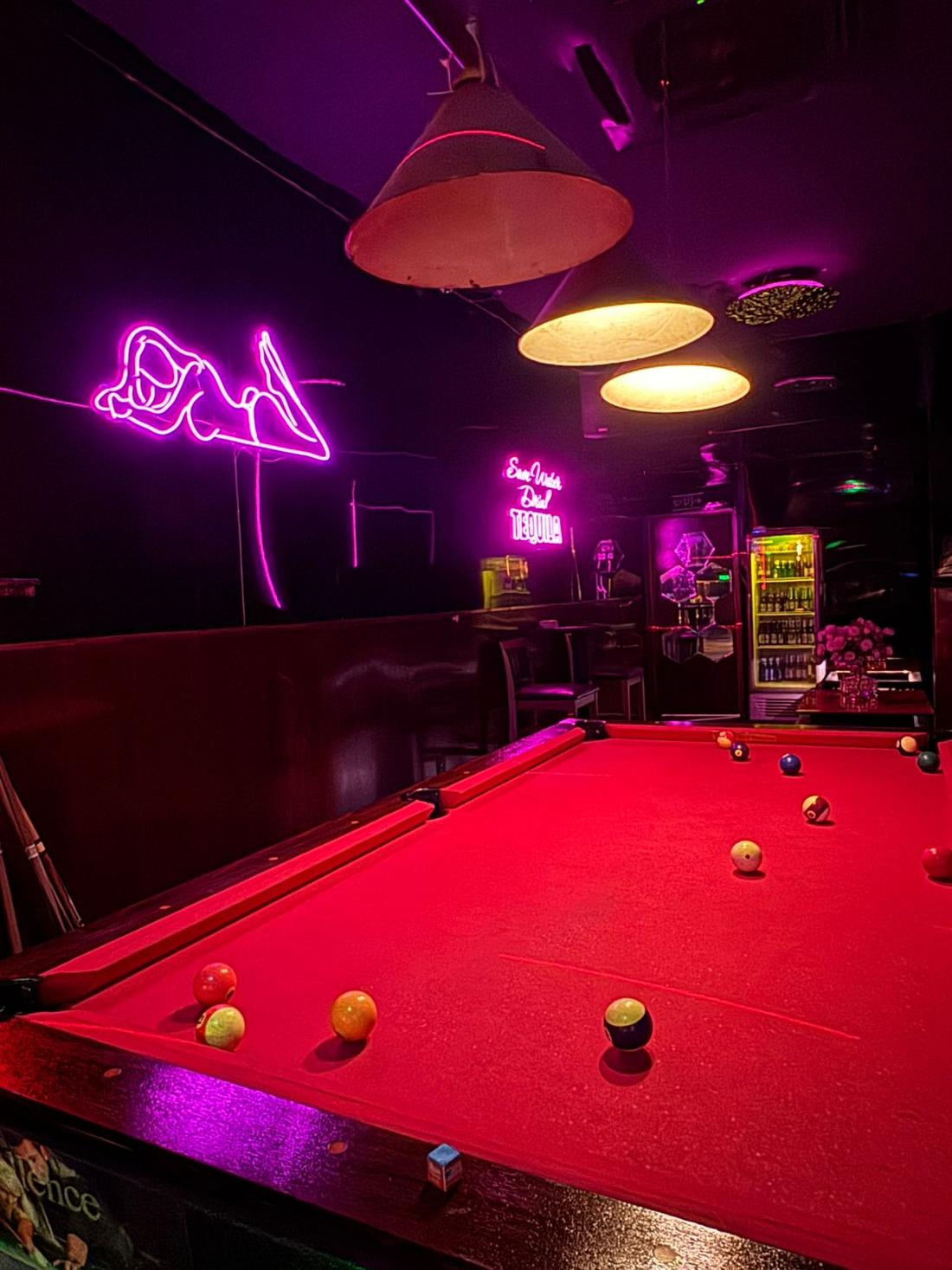 Pool table at Honey Bar Saigon under neon lights